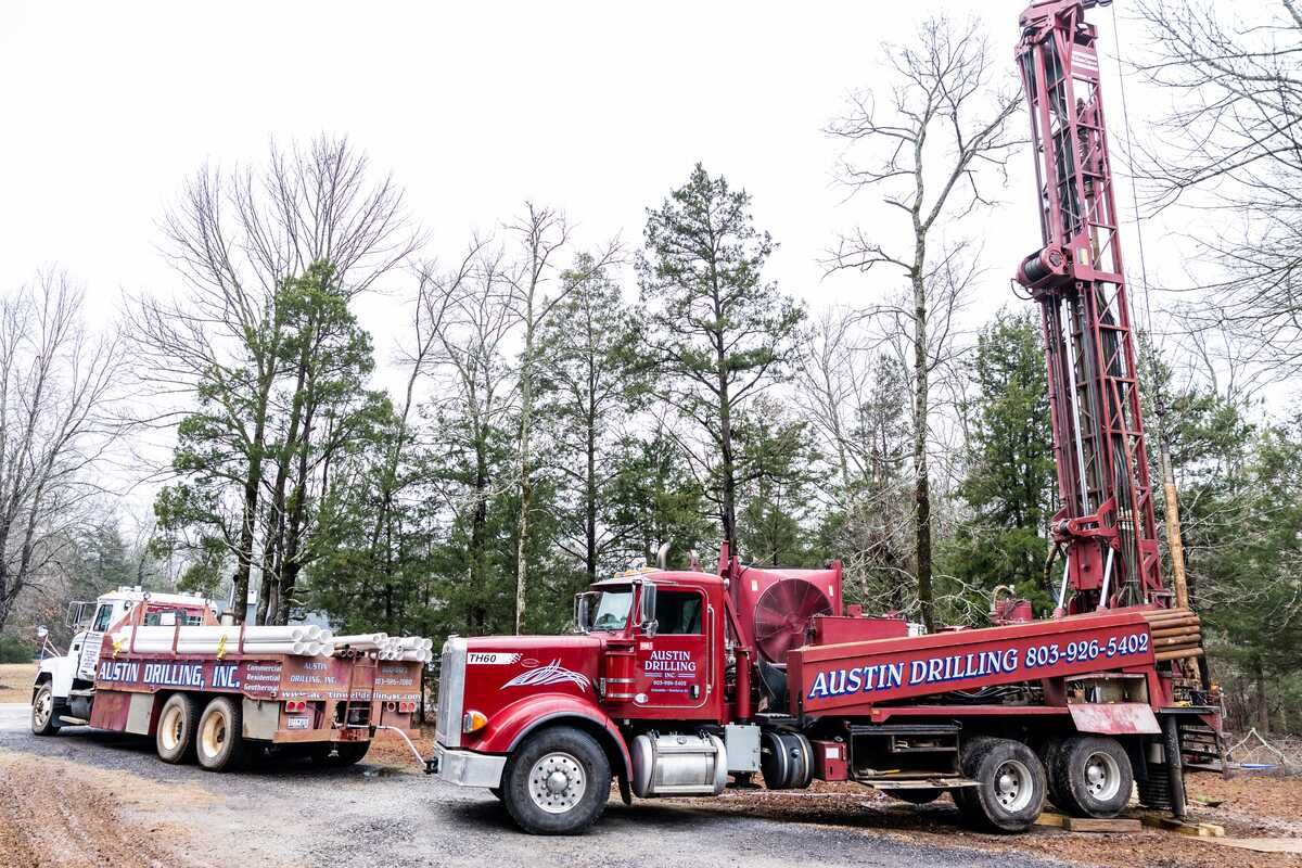 Austin Drilling rig and support truck set up on a residential job site