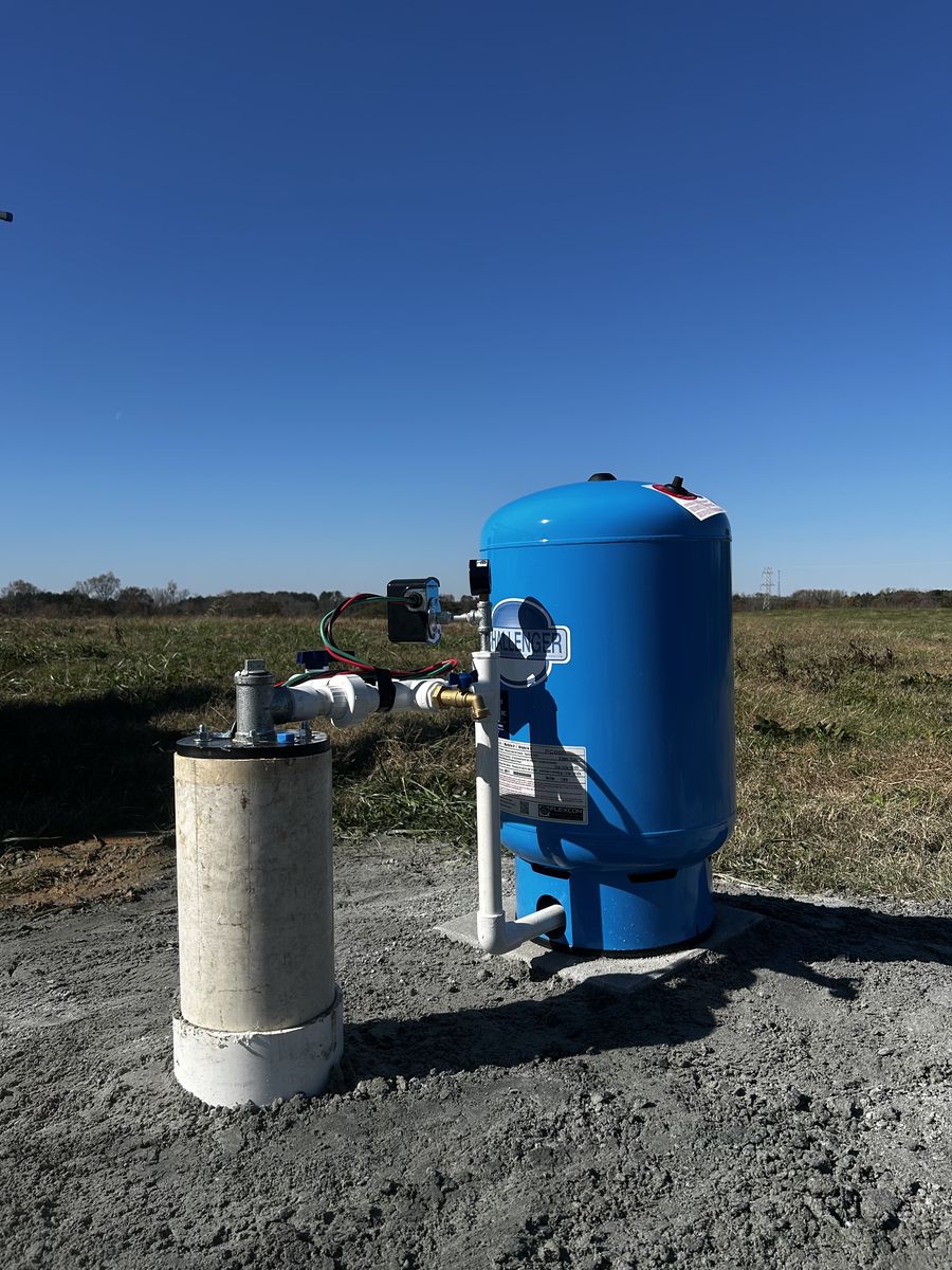Well pressure tank and water treatment equipment installed by a wellhead